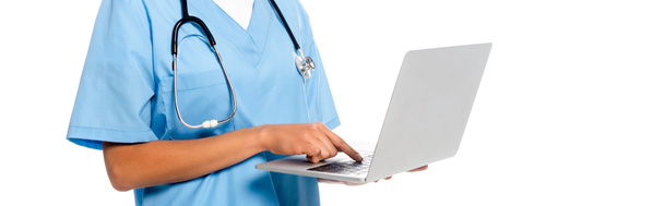 Cropped view of african american nurse with stethoscope focused on using laptop isolated on white, panoramic shot - Photo, Image