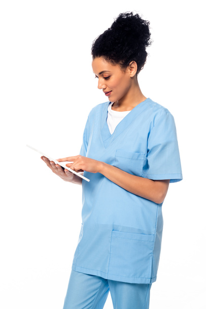 African american nurse using digital tablet isolated on white - Zdjęcie, obraz