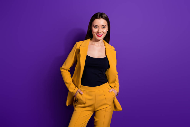 Portrait of pretty cool content girl put hands trousers relax rest on her luxury party stand copyspace isolated over purple color background - Fotó, kép