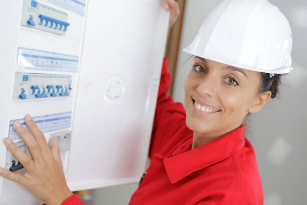 portrait of a happy female electrician - Photo, image