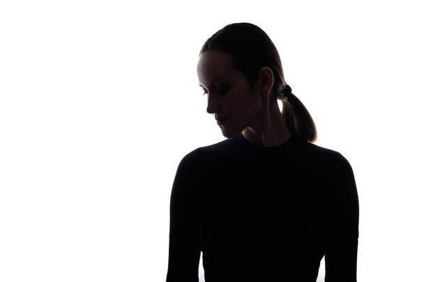 black and white silhouette portrait of caucasian woman with her head down - Foto, Bild