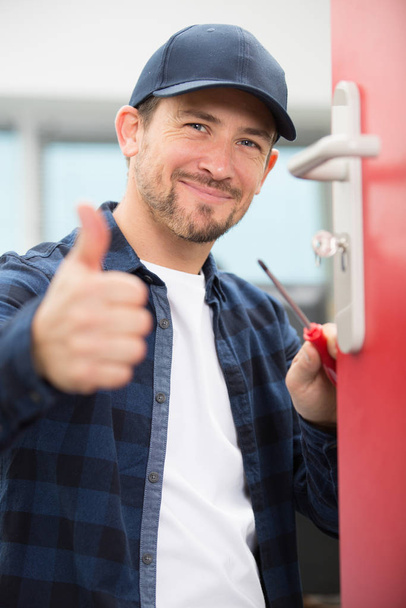 young man worker showing thumb up - Foto, Imagem