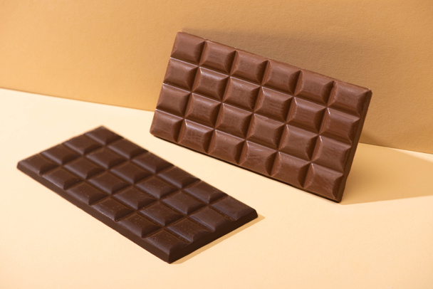 sweet delicious dark, milk chocolate bars on beige background - Photo, image
