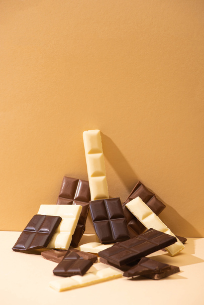 sweet delicious dark, milk and white chocolate on beige background - Foto, Imagem