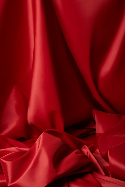 close up view of red soft and crumpled silk textured cloth - Φωτογραφία, εικόνα
