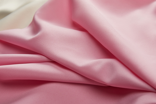 close up view of satin pink and white soft and wavy fabric - Фото, изображение