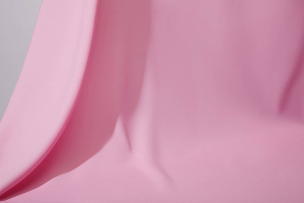 close up view of pink soft wavy fabric isolated on grey - Φωτογραφία, εικόνα