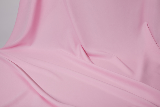 close up view of pink soft wavy fabric isolated on grey - Fotó, kép