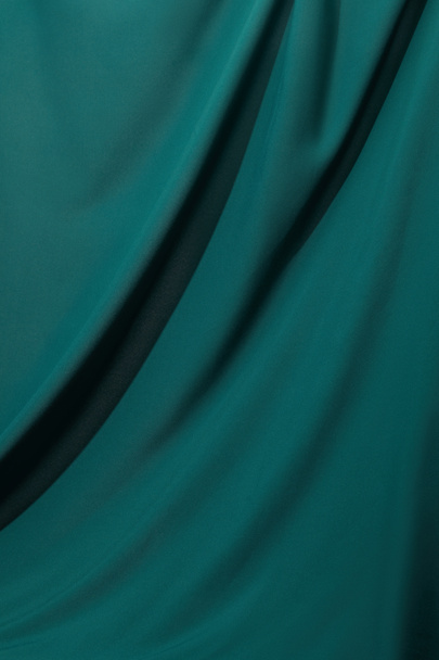 close up view of emerald soft and wavy silk fabric - Фото, изображение
