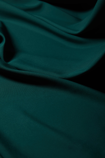 close up view of emerald soft and wavy silk fabric - Φωτογραφία, εικόνα