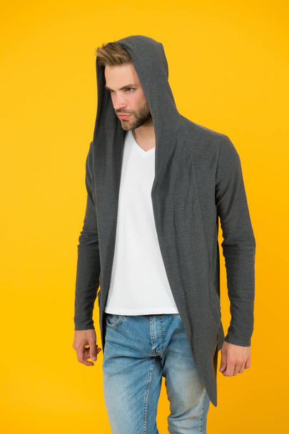 Comfy garment for daily life. Fashion man yellow background. Fashion look. Handsome guy wear fashionable mantle with hood. Casual wear for men. Fashion trends. Modern clothes for youth. Sporty style - Photo, Image