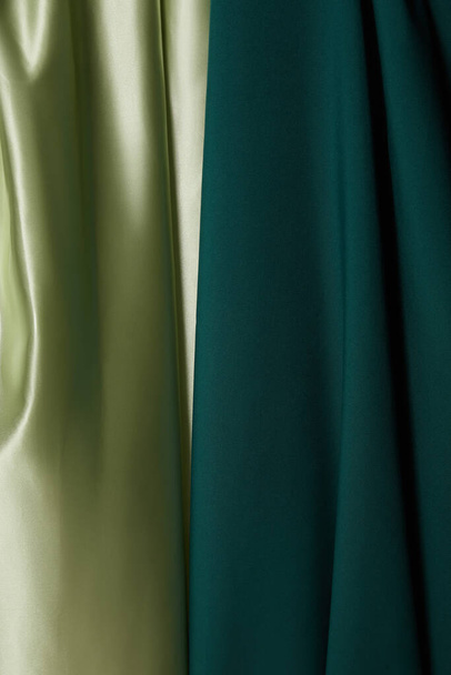 close up view of emerald, light green soft and wavy silk fabric - Foto, Imagem