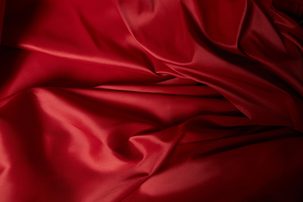 close up view of red soft and crumpled silk textured cloth - Photo, Image