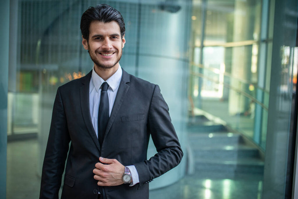 Portrait of a smiling businessman in a modern business environment - Foto, afbeelding
