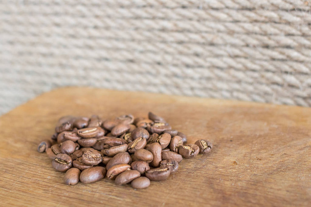 A handful of coffee beans. Grade Arabica. Hot coffee drink. Strong espresso. Grains of medium frying. The menu in the coffee shop. Fragrant drink. Coffee bean close-up. An invigorating morning drink. - Photo, Image