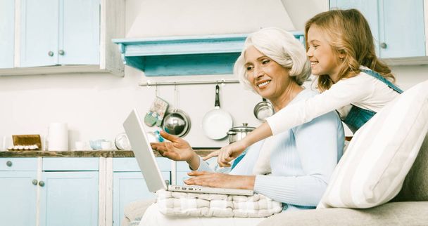 Friendly Family Granny And Little Girl Using Laptop - Фото, изображение