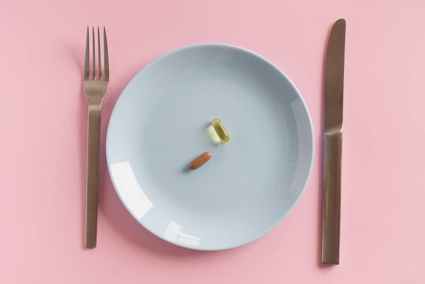Drugs on white plate with fork and knife - Photo, Image