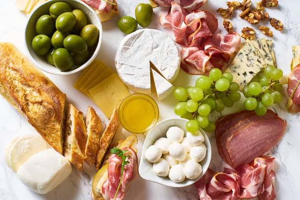 Big plate of appetizers on marble board, party of breakfast concept   - Фото, изображение