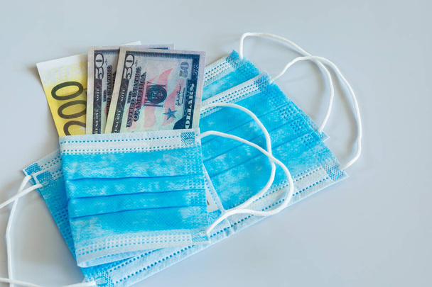 The concept of rising prices and scarcity of medical masks in the world due to the spread of the virus. - Foto, Imagen