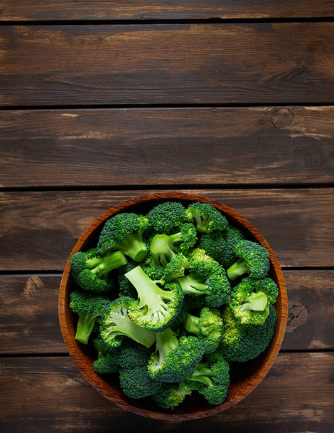 fresh broccoli on wooden surface - Фото, зображення