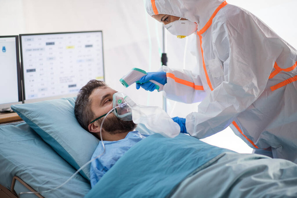 Infected patient in quarantine lying in bed in hospital, coronavirus concept. - Фото, зображення
