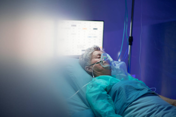 Infected patient in quarantine lying in bed in hospital, coronavirus concept. - Φωτογραφία, εικόνα