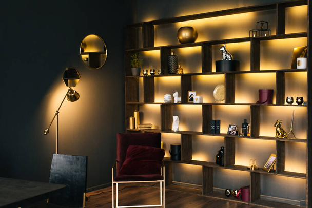 The interior of a modern apartment in black with yellow lighting. Beautiful interior decor - 写真・画像