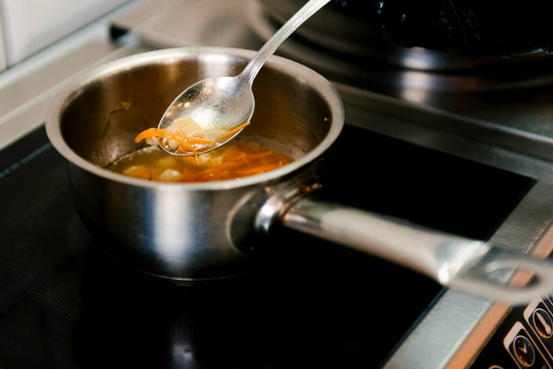 Cooking soup on the stove, lunch menu in a cafe, selective focus - Photo, Image