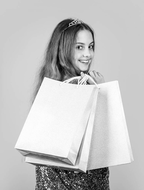 Shopping is always good idea. Happy girl hold shopping bags. Little child enjoy shopping. Small shopper blue background. Shopping and sale. Black Friday. Cyber Monday. Shop now, copy space - Foto, Bild