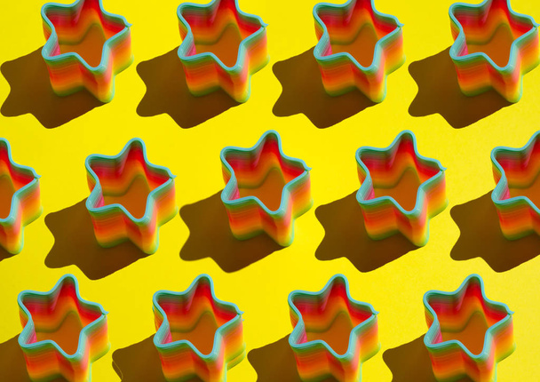 pattern of ranbow toy on yellow background - Zdjęcie, obraz