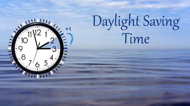 Daylight Saving Time (DST) Wall Clock on sea landscape. Turn time forward. Abstract photo of changing time at spring. - Photo, Image
