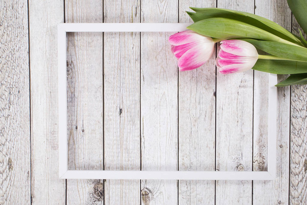 Spring background with tulips , frame on the wodden background - Zdjęcie, obraz