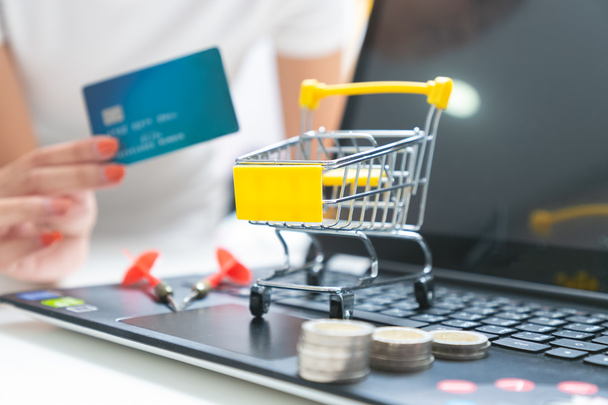 Pushcart or shopping trolley basket and credit card in shopping. - Photo, Image