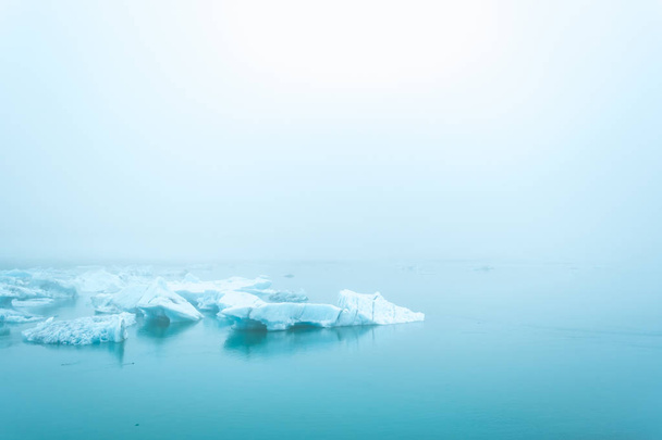 Misty glaciers in the blue waters of Jokulsalron glacial lake in Iceland - Photo, Image