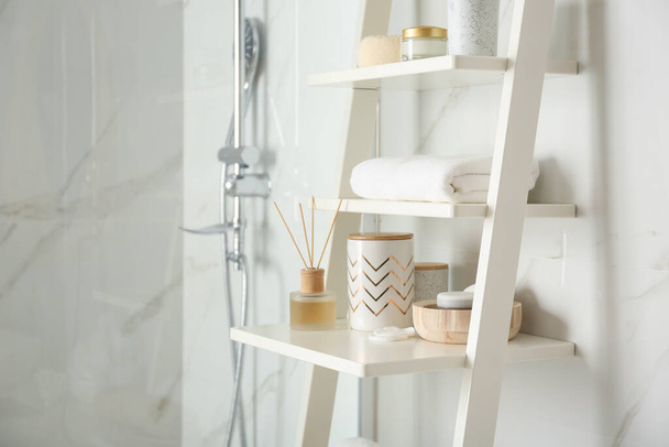 Shelving unit with different items in bathroom interior - Photo, image