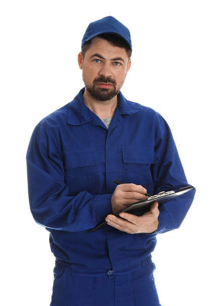 Portrait of professional auto mechanic with clipboard on white background - Foto, afbeelding