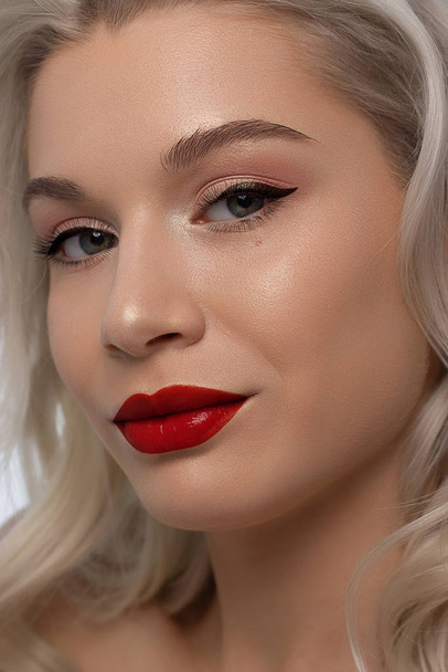 Closeup portrait of a woman with developing straight hair. Sweet tender young girl blonde. Natural lipstick, transparent clean skin. Skin care natural cosmetics in the spa salon or cosmetology. - Foto, Bild