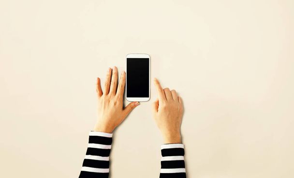 Person using a white smartphone - 写真・画像