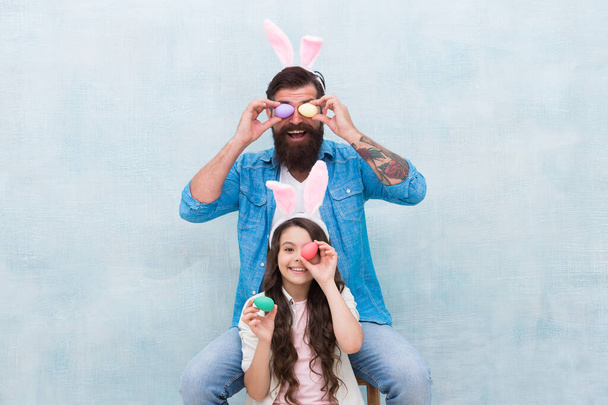 Family dad and daughter wear bunny ears. Father and child celebrate easter. Spring holiday. Easter activities. Seasonal sale and discount. Happy easter. Holiday bunny. Family tradition concept - Photo, Image