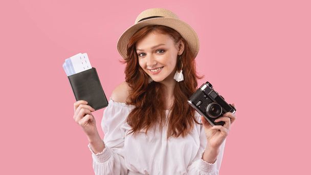 Cute Traveler Girl Holding Tickets And Camera On Pink Background - Fotó, kép