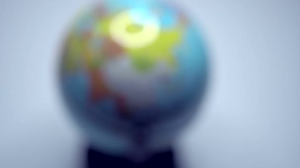 Schulkugel. Ein Mann dreht auf einer Erdkugel und zeigt auf sie. Kugelförmige Form der Erde. Planet im Miniaturformat. Globus mit Staubpartikeln im Klassenzimmer. Europa - Filmmaterial, Video