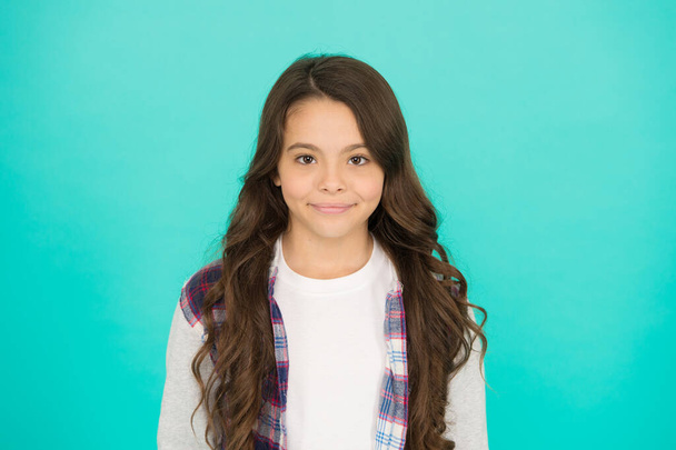 Happy international childrens day. Little girl turquoise background. Good mood concept. Positive vibes. Fashion shop. Shopping day. Feeling cool. Cute girl with long hair. Small girl checkered shirt - Foto, afbeelding