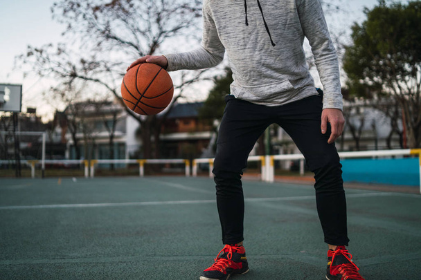 Portrait of young basketball player playing outdoors. Sport concept. Basketball concept. - Fotoğraf, Görsel