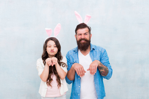 Having fun on Easter. Smiling father and daughter. bunny family fun. happy family time. wearing rabbit ears for spring holiday. Daughter and father hunting eggs for Easter holiday - Zdjęcie, obraz