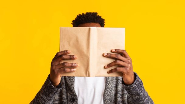 Young african student pretended as if he was reading a book - Foto, immagini