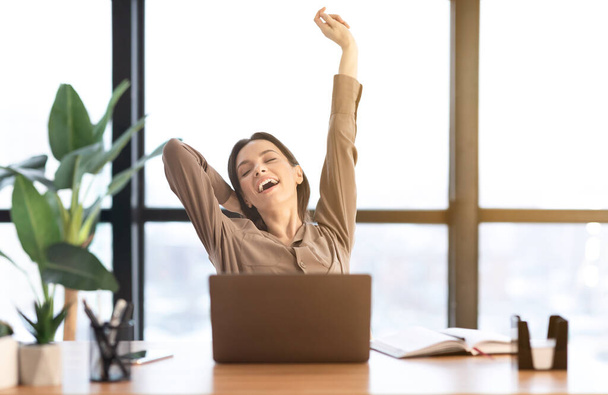 Happy european manager stretching body at work - Photo, Image