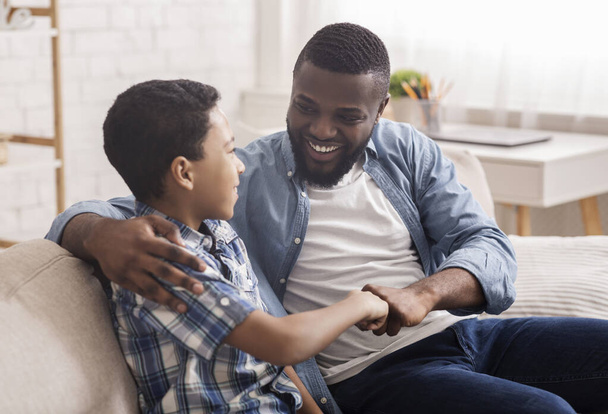 Cheerful Black Boy Bumping Fists With His Dad At Home - Photo, Image
