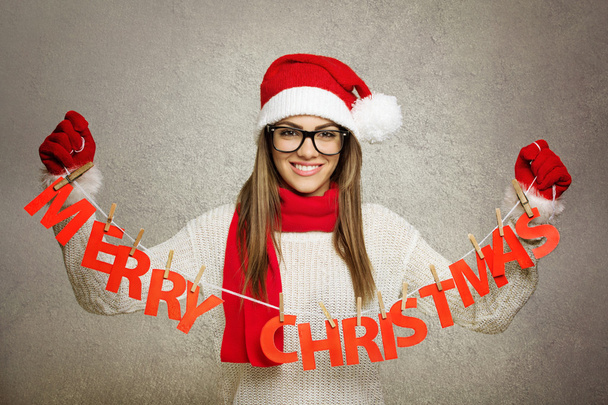 Beautiful young Santa girl with Merry Christmas text decoration - Foto, Imagen