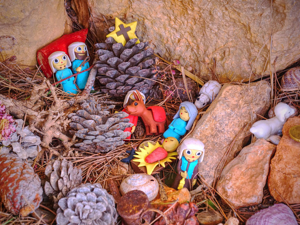 Childrens toy Nativity built in rocks. Presents from hikers walk around. Pintal Vermell pass, Mallorca island. Figures from a nativity scene or set with Jesus Christ, Mary and Joseph - Photo, Image