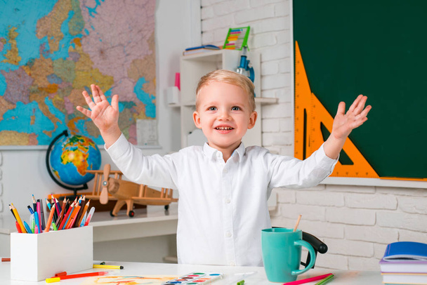 Education. Portrait of Pupil in classroom. Kids from primary school. Little ready to study. School interiors. Cute pupil with funny face schooling work. - Zdjęcie, obraz